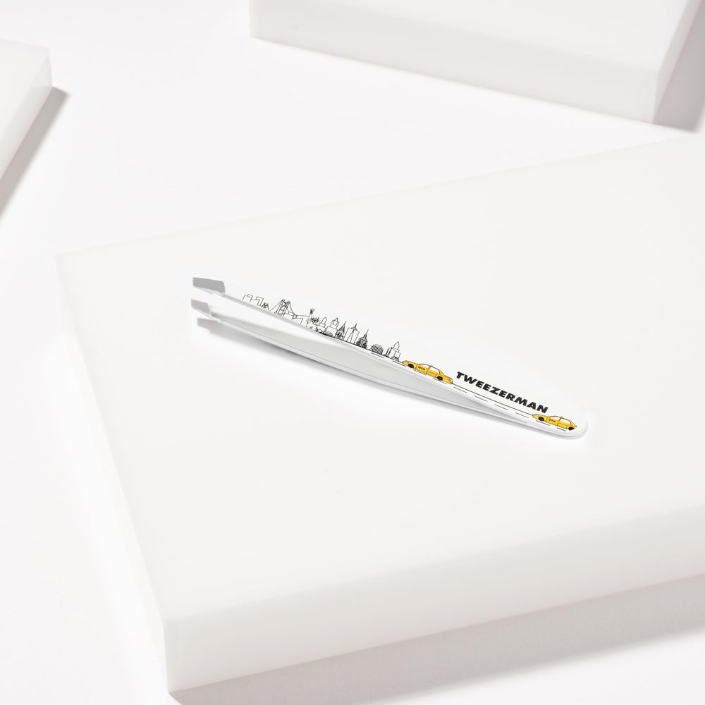 Tweezerman tips gripping single hair to show dependable precision and accuracy