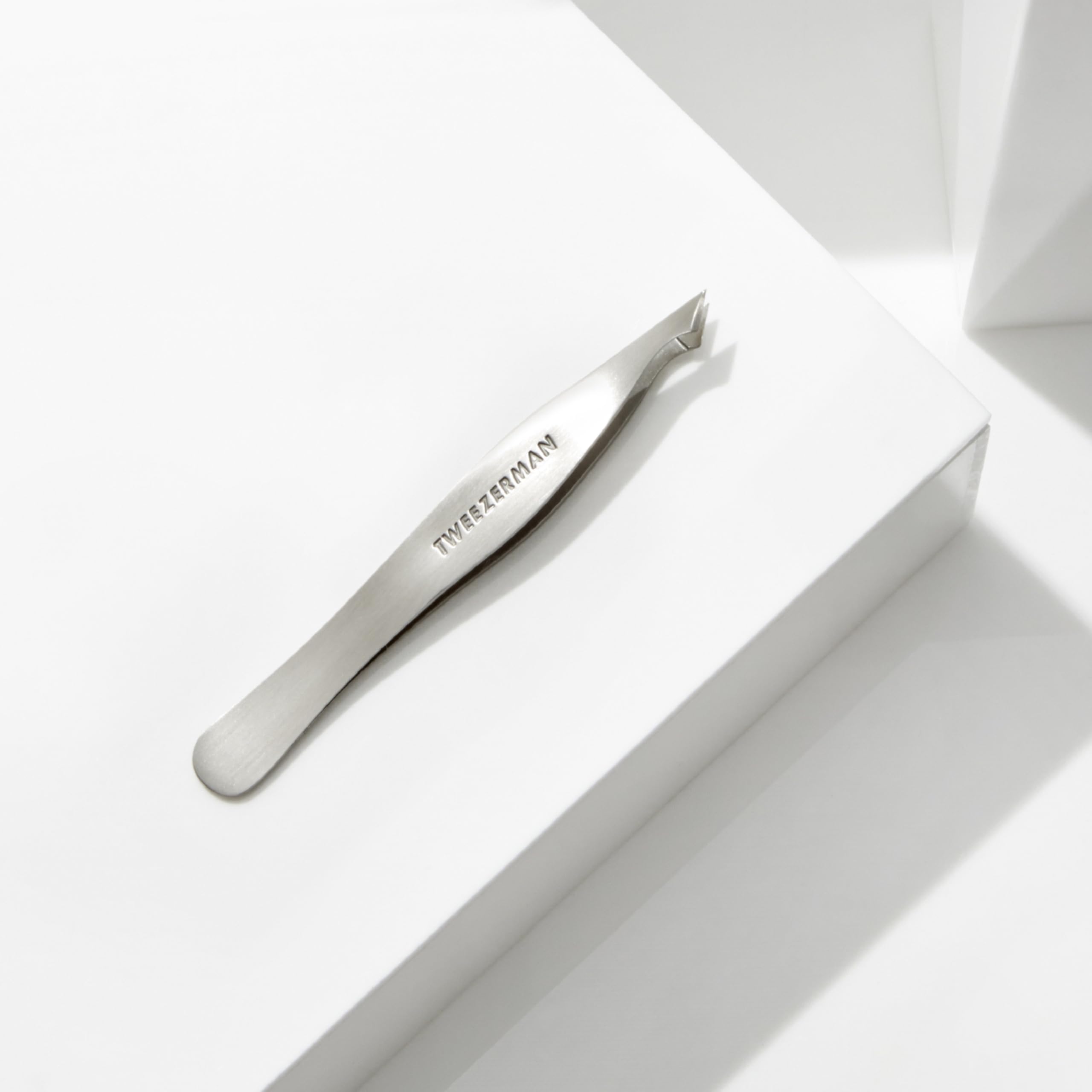 Tweezerman stamped label and polished finish showing durable stainless steel build and quality