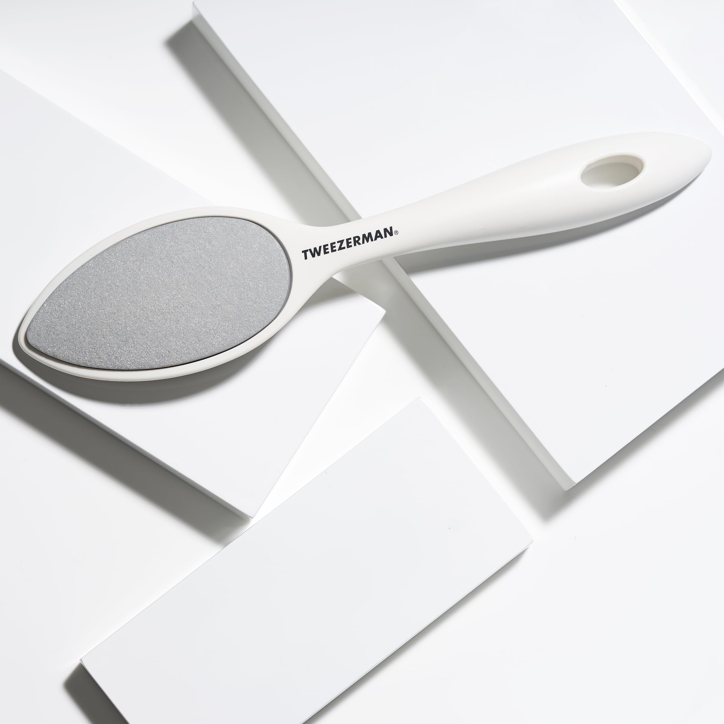Tweezerman Sole Smoother rinsed under water showing easy cleaning advantage
