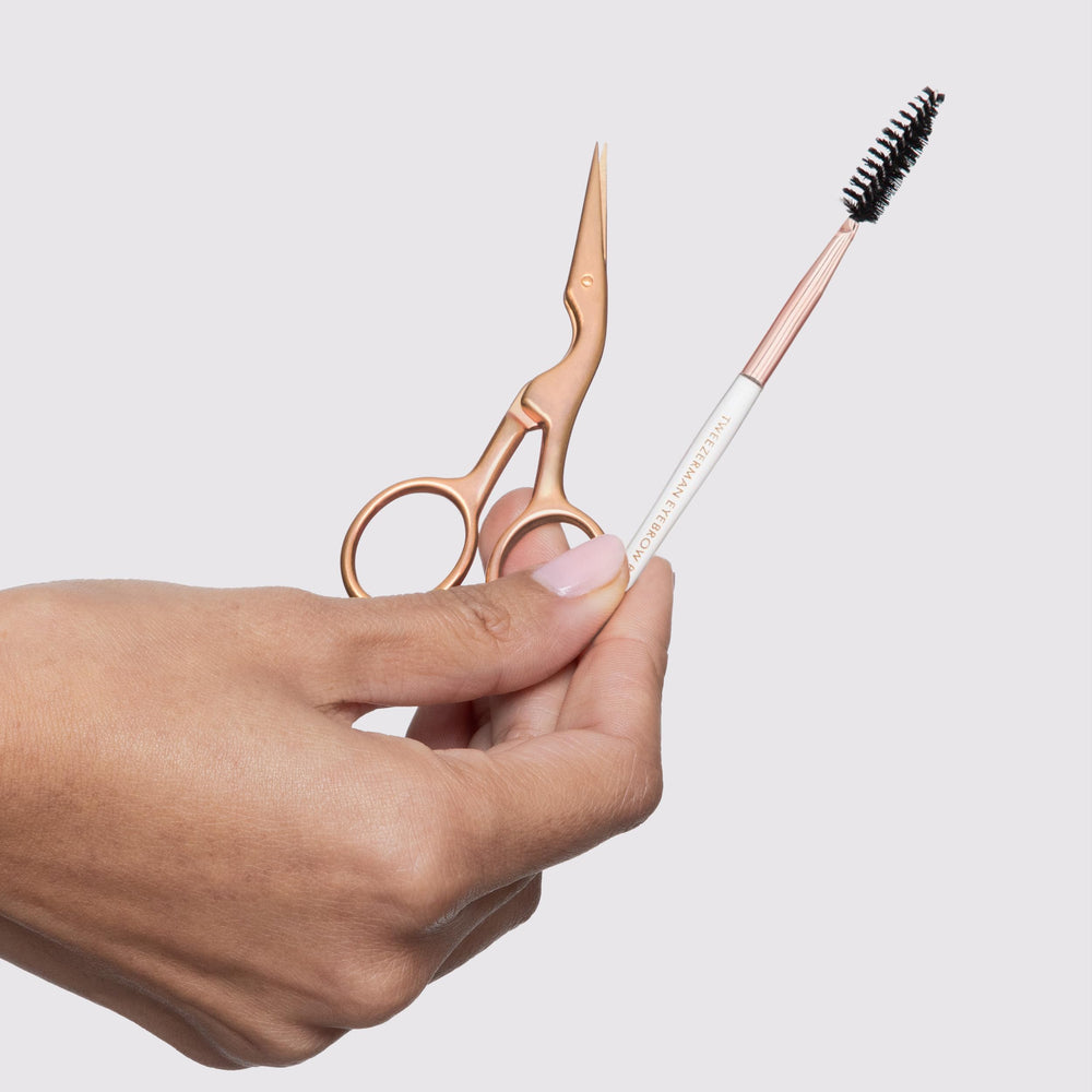 Tweezerman trimming in use on brow showing careful hair removal and shaping benefit