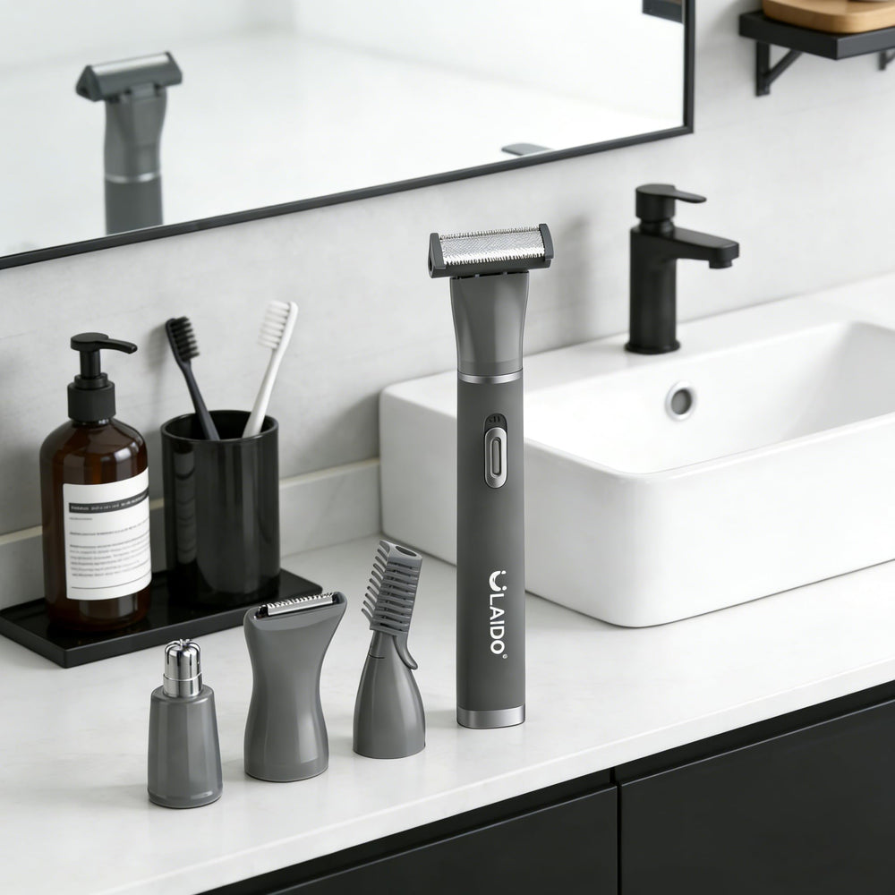 ULAIDO groomer in hand for scale showing compact size and travel-friendly design