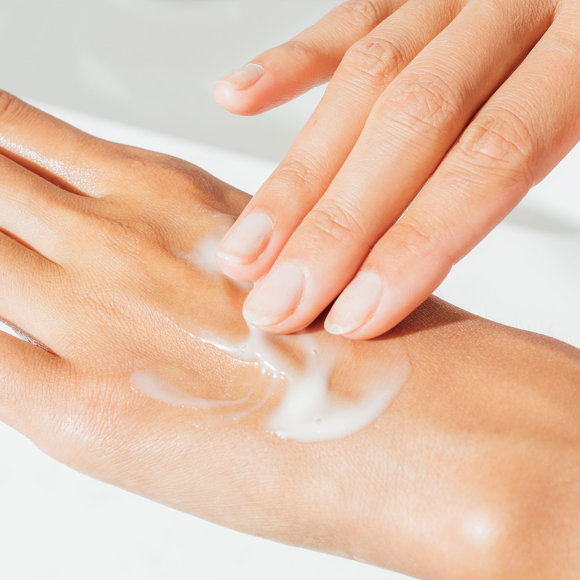 Woman smoothing Ursa Major gel on face to reduce redness and hydrate