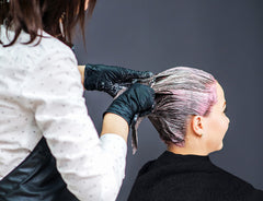 Utopia Towels in use with stylist wrapping hair, demonstrating salon-ready fit