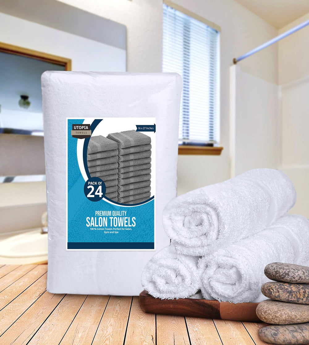Utopia Towels held in hand for scale to show 16x27 inch salon towel size benefit