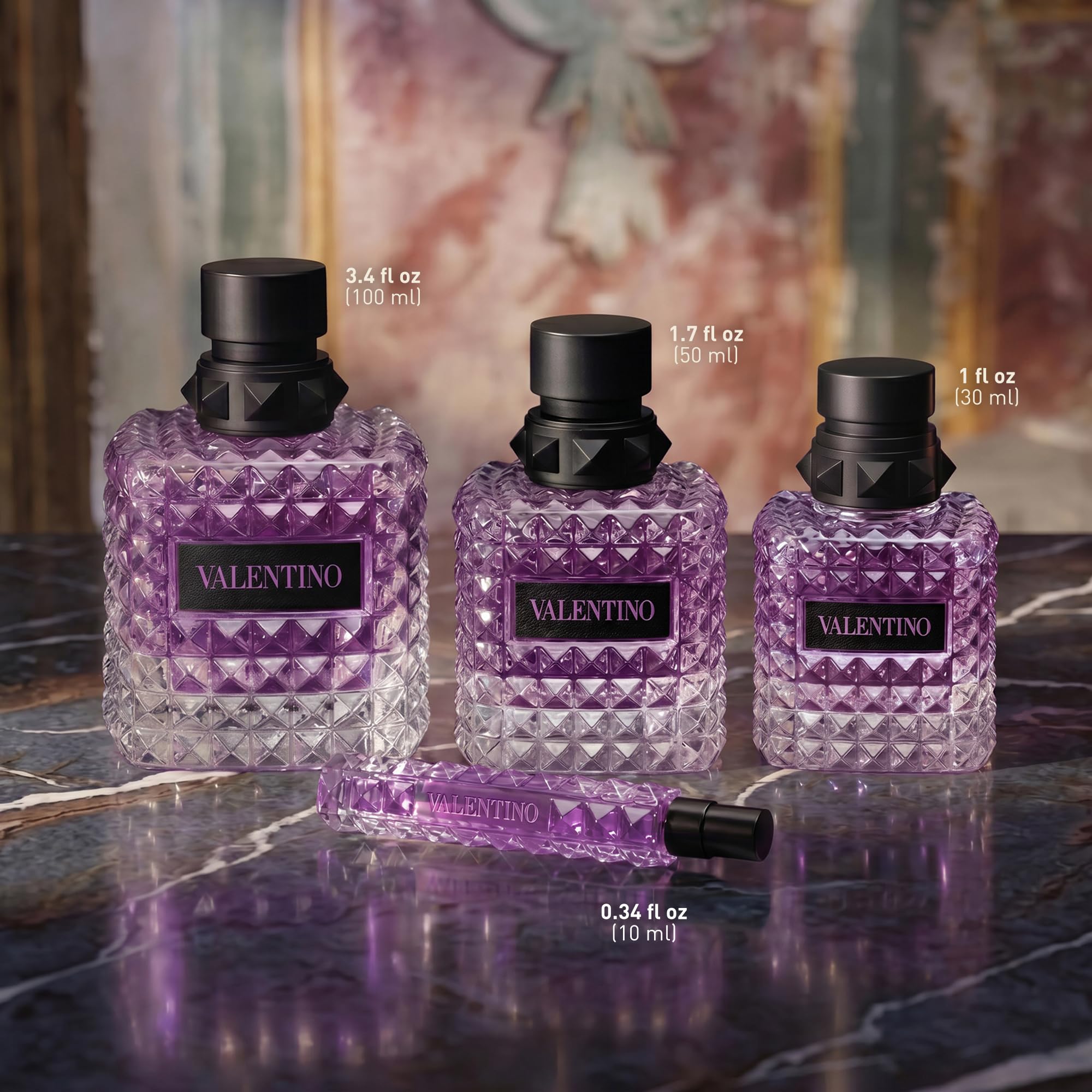Valentino bottle beside common items to show 3.4 fl oz scale