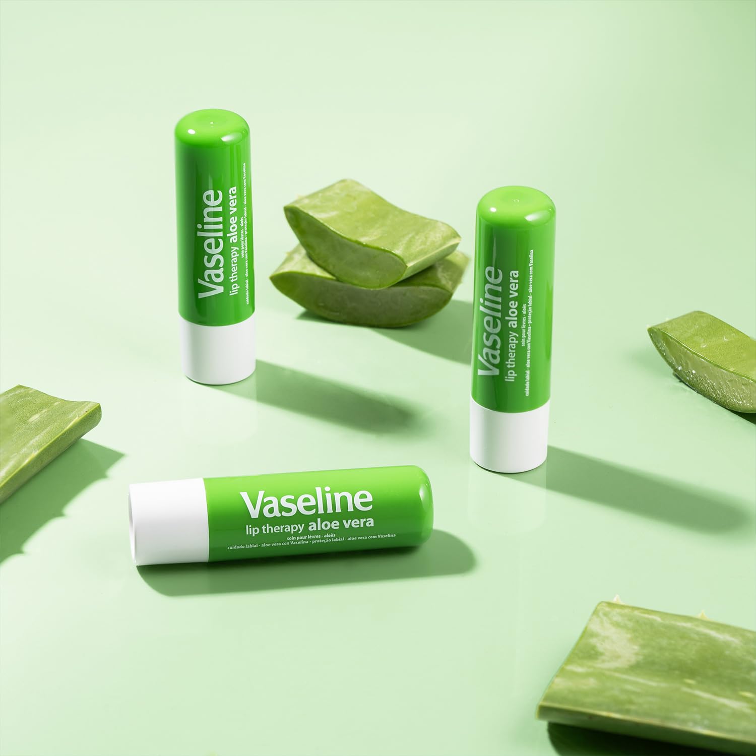 Vaseline stick held in hand to show compact travel-friendly scale