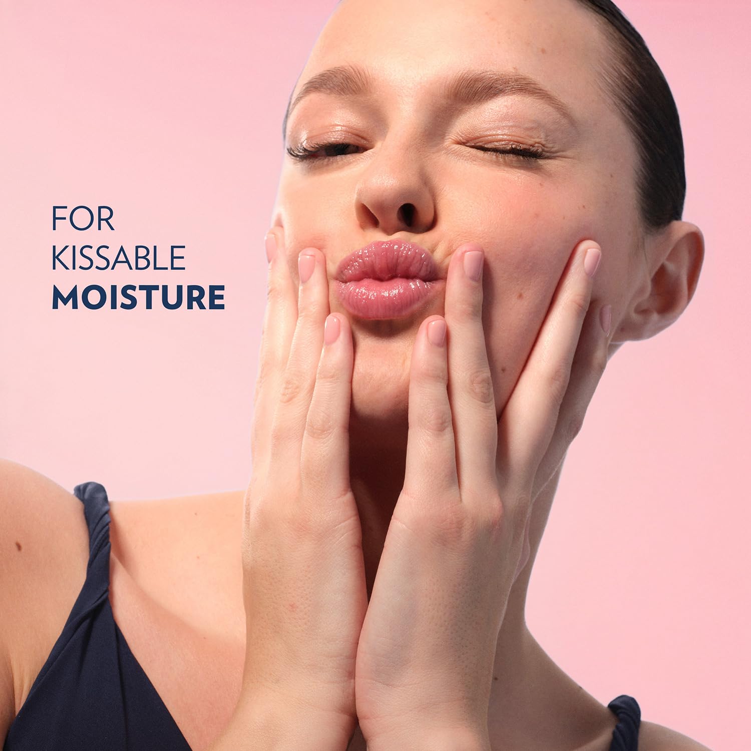 Person applying Vaseline rosy lips outdoors for instant lip protection