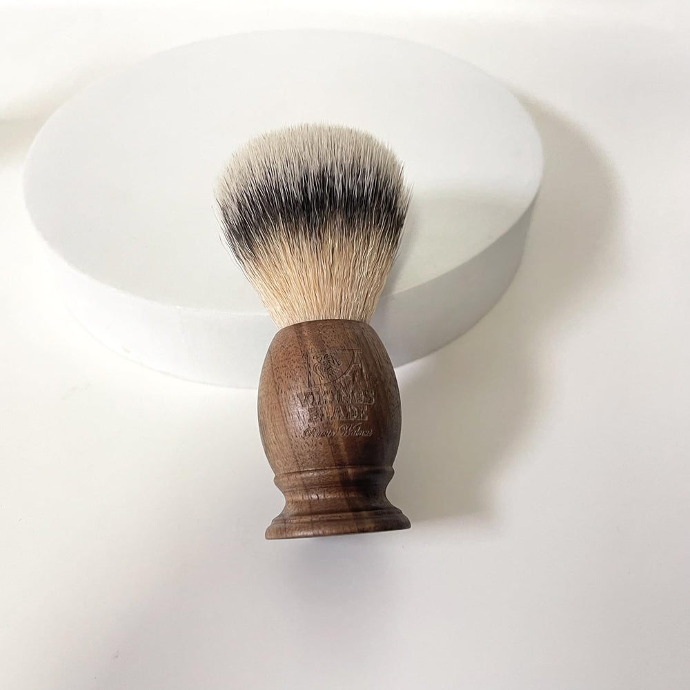 VIKINGS BLADE brush next to razor showing compact size and scale