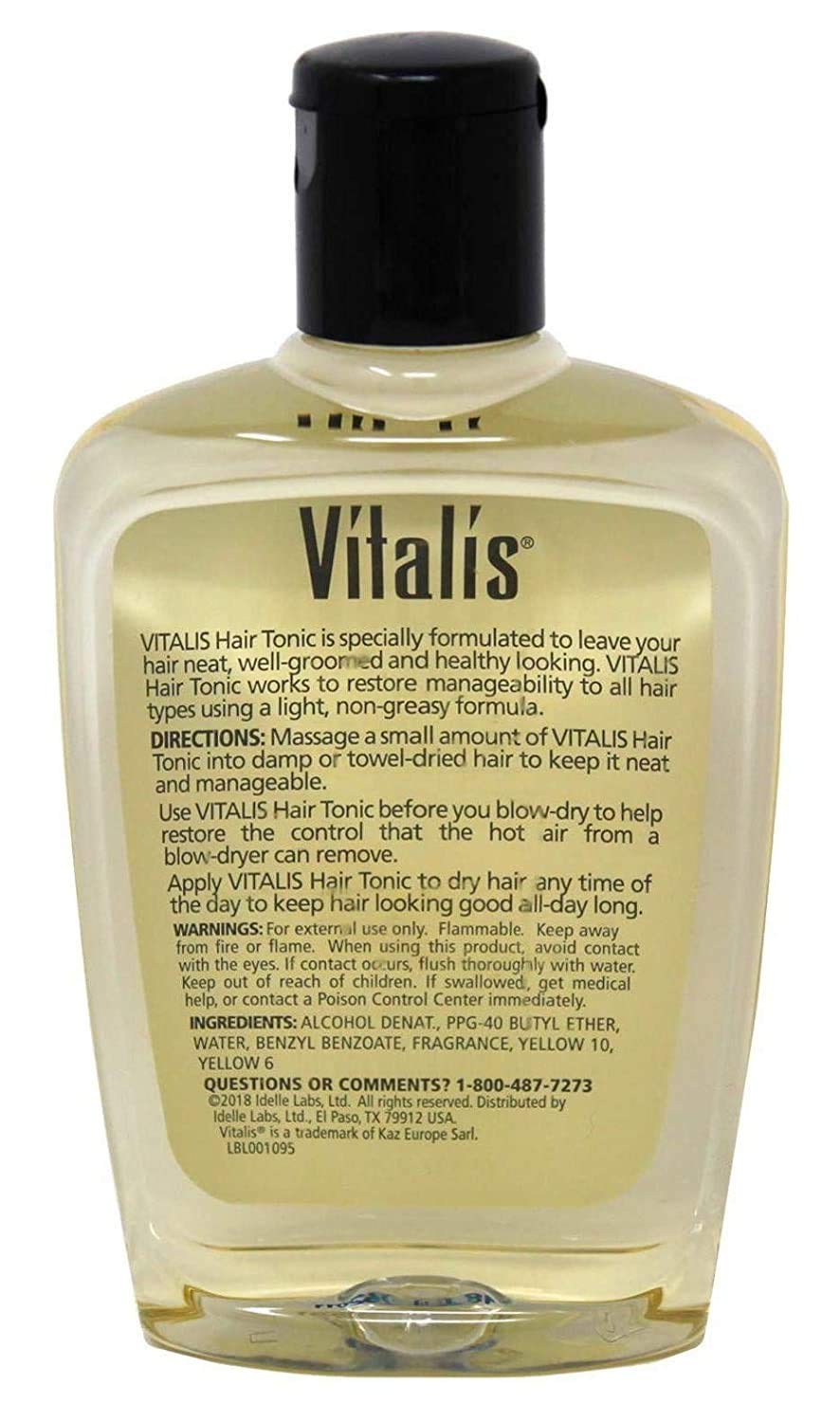 Vitalis tonic in hand being applied for smoother, more manageable hair
