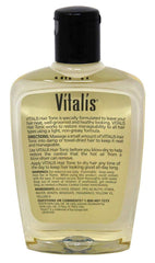Vitalis tonic in hand being applied for smoother, more manageable hair