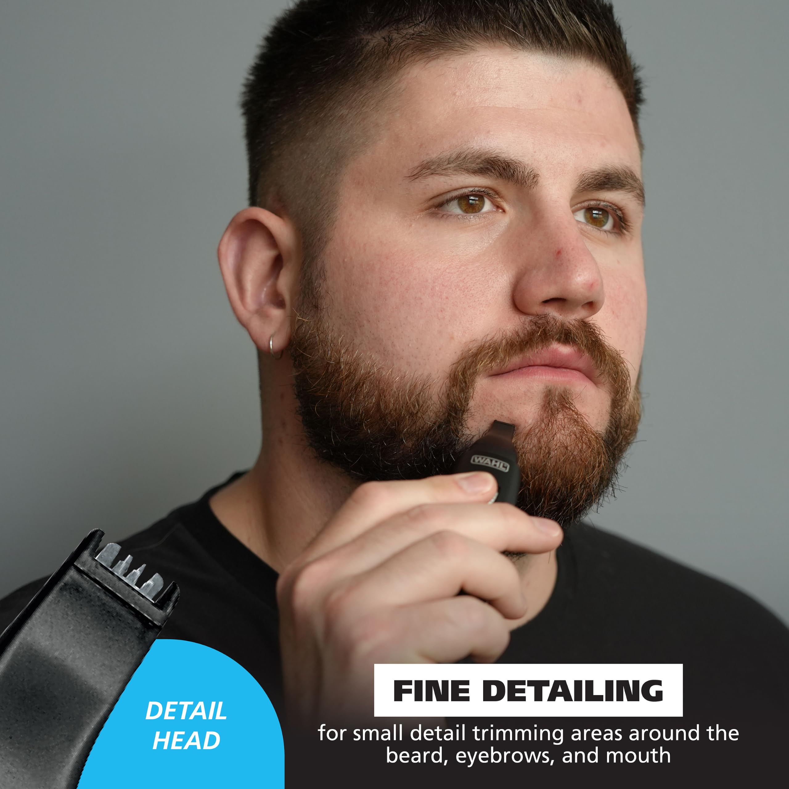 Wahl trimmer held in hand illustrating compact size for travel convenience