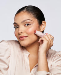 Wander Beauty applying and blending blush on cheek for natural flushed finish