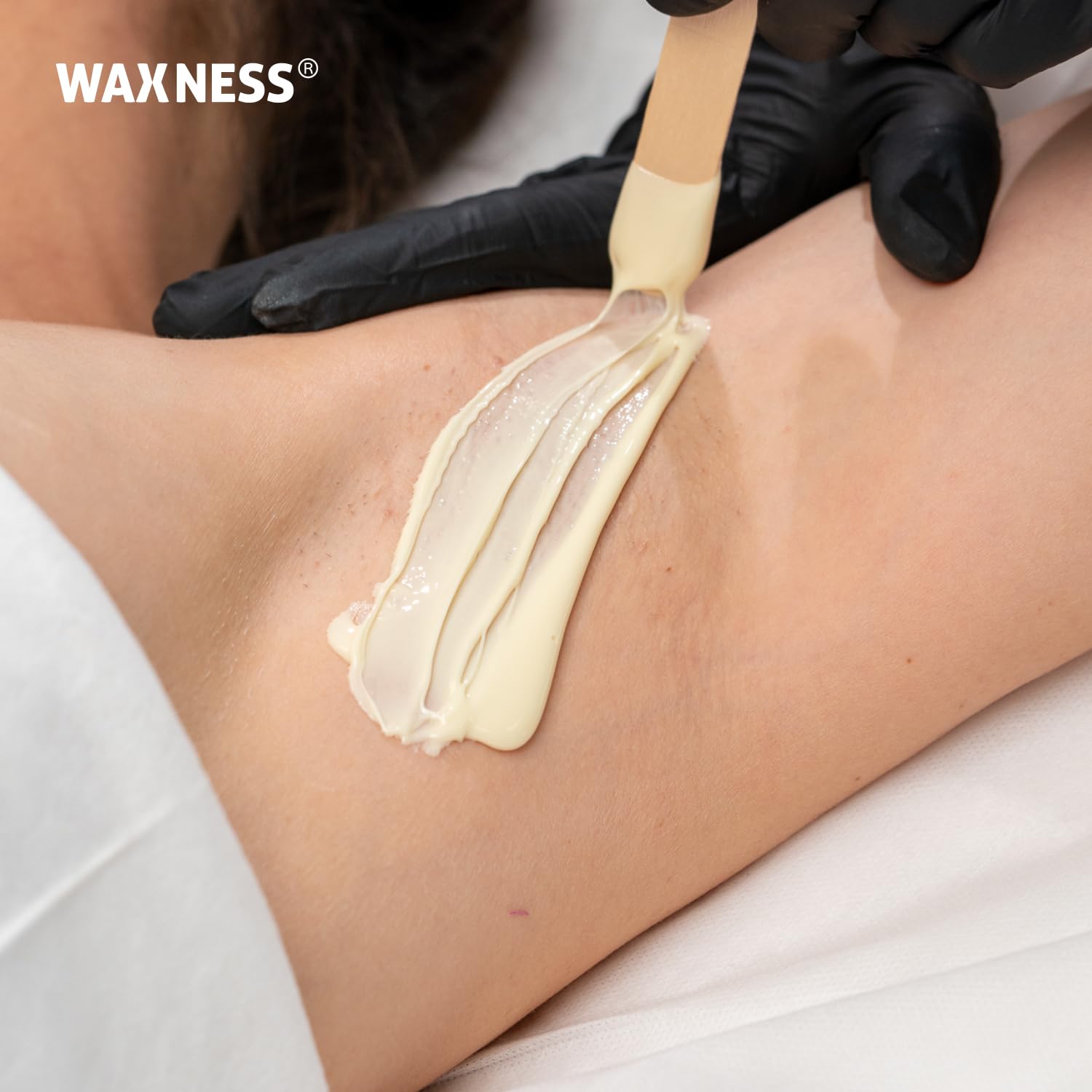 Aesthetic salon scene with Waxness beads and tools indicating professional treatment setup