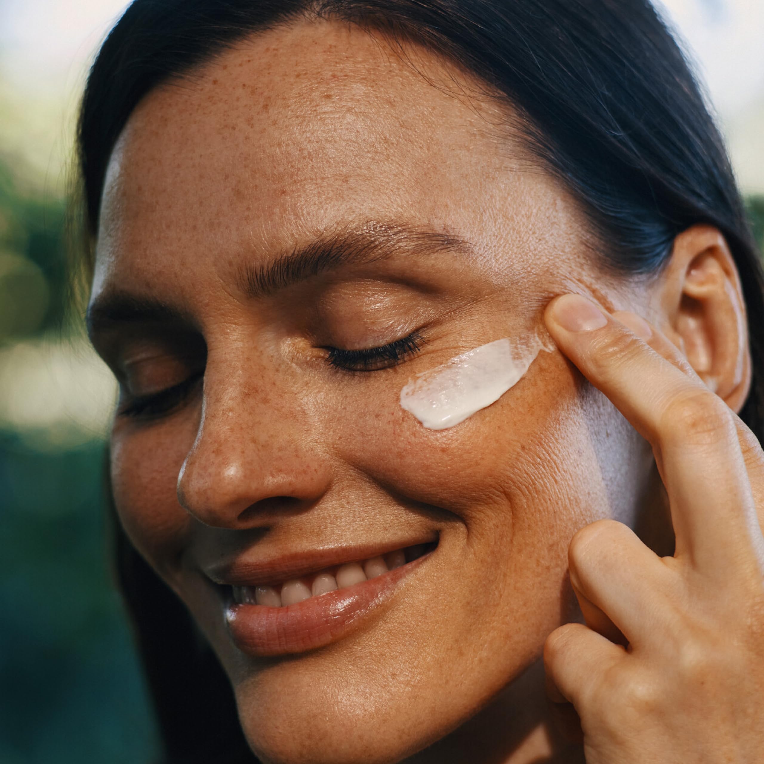 Weleda cream on fingers demonstrating easy absorption and moisture