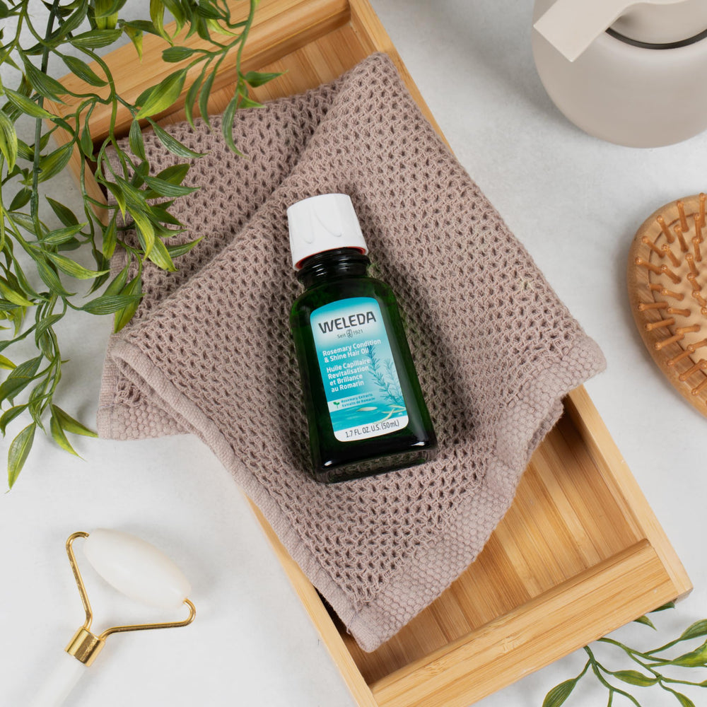 Detailed view of Weleda rosemary hair oil label highlighting botanical ingredients and brand reassurance