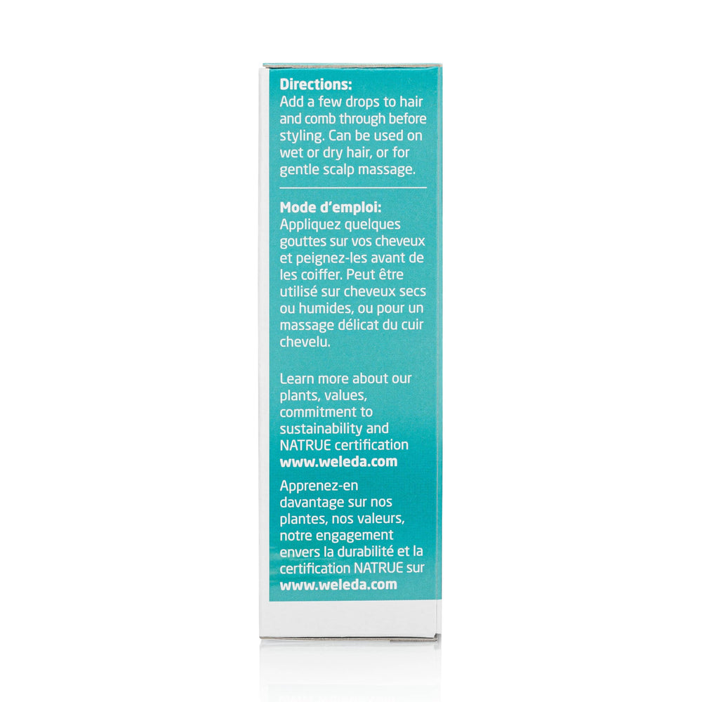 Close-up of Weleda rosemary hair oil texture on fingers showing lightweight spreadability and absorption