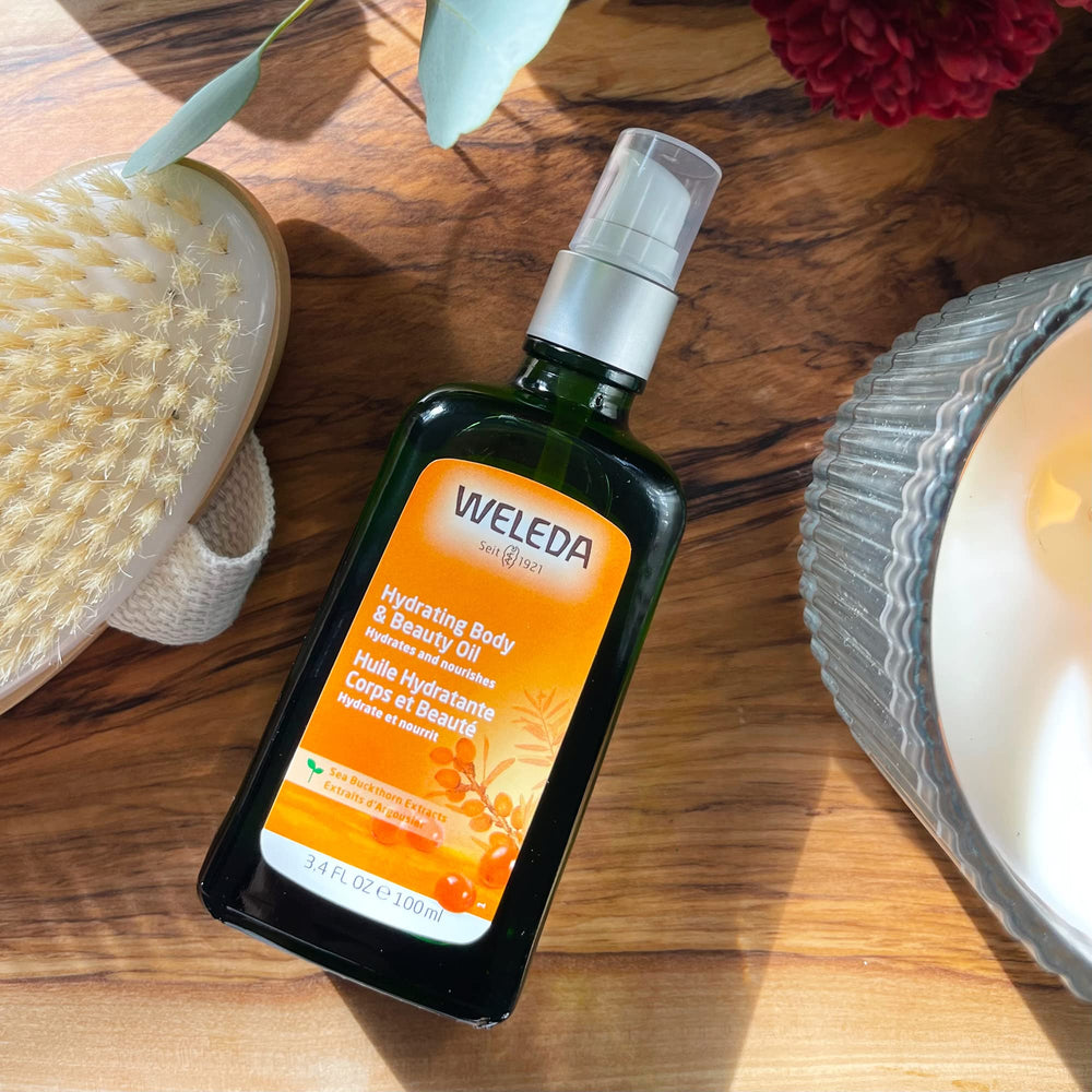 Weleda 3.4 fl oz bottle held in hand to show compact travel size