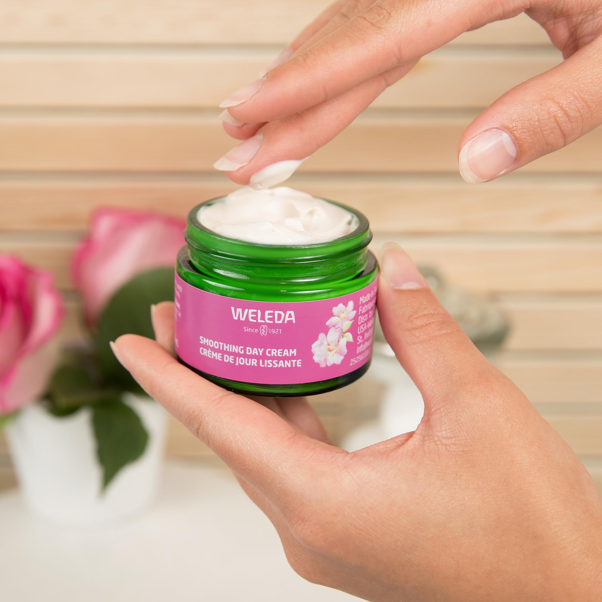 Weleda smoothing day cream next to ruler showing compact size and portability