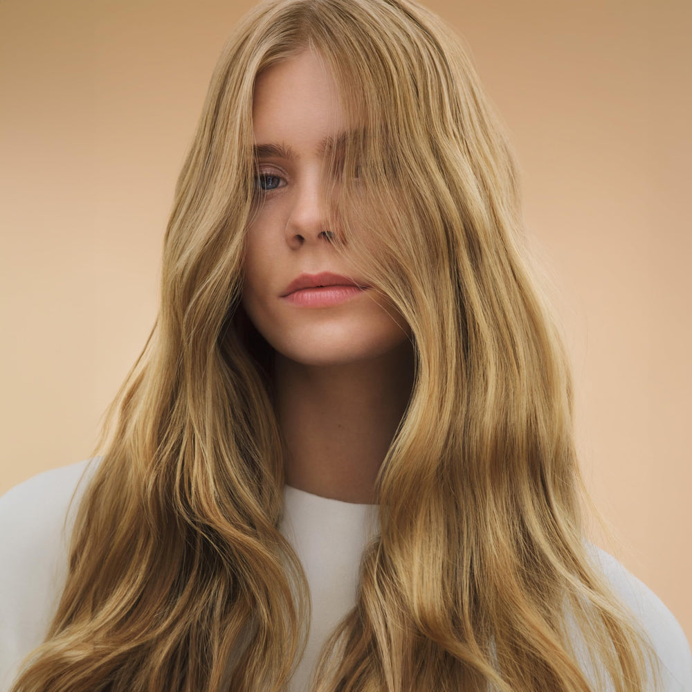 Wella Professionals before and after strands showing smoother, shinier hair