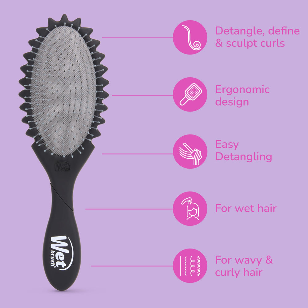 Wet Brush held in hand demonstrating compact travel-friendly size