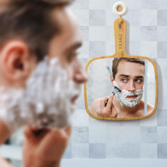 YEAKE mirror held by person styling hair for accurate grooming
