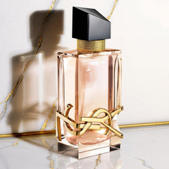 Yves Saint Laurent Libre on vanity with flowers showing stylish everyday use